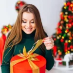 happy woman opening Christmas gift