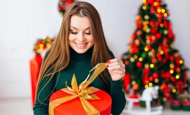 happy woman opening Christmas gift